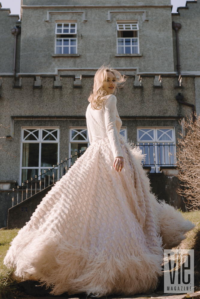 Irish model Clara McSweeney running up stairs at Ballynahinch Castle in Christian Siriano gown