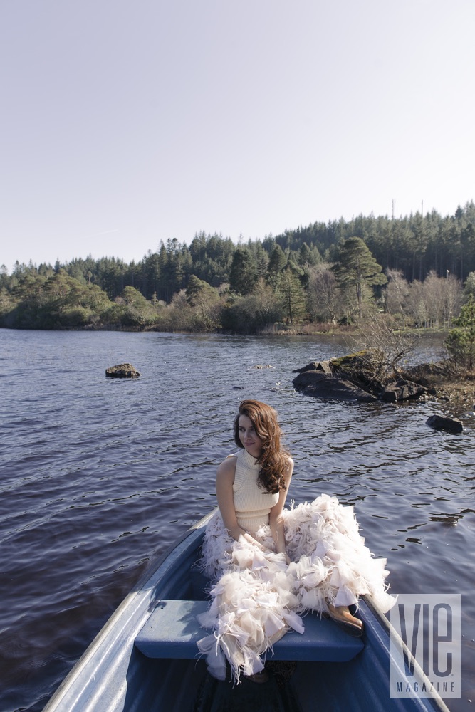 Faye Dinsmore in a boat at Ballynahinch Castle Christian Siriano gown