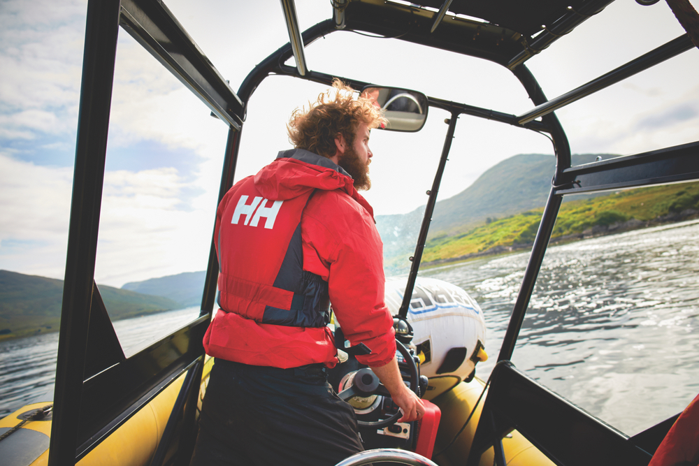 Man driving boat on lake in Western Ireland