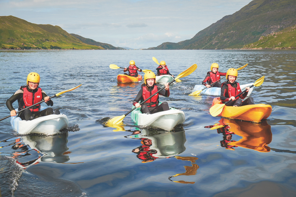 Group kayaking in lake in Western Ireland