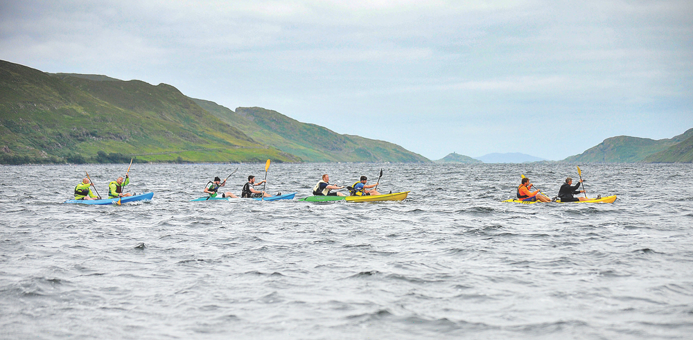 Group kayaking in lake in Western Ireland