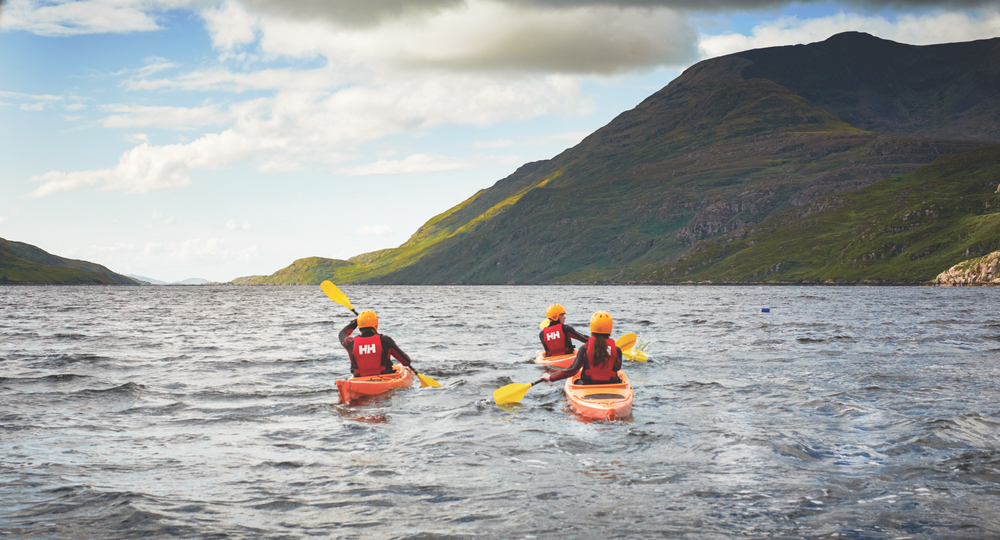 Group kayaking in lake in Western Ireland