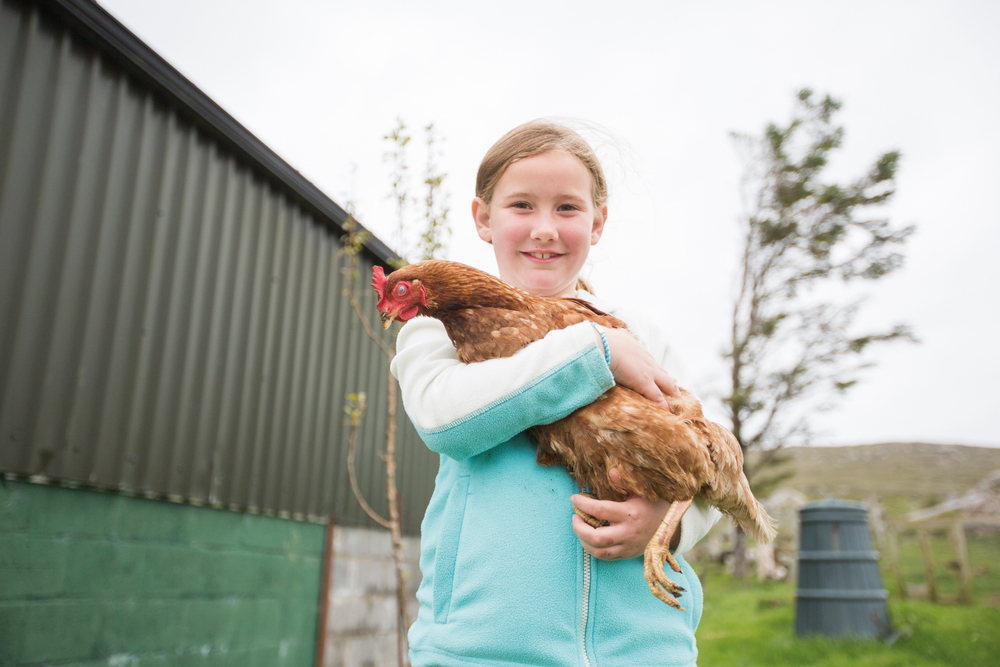 Maria Gorham holding a chicken at Glenbricken Farm The Sophisticate Issue Connemara Life