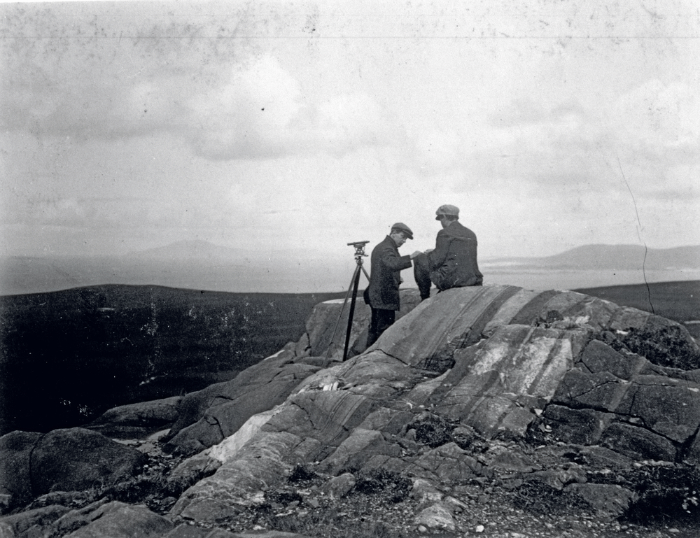 Engineer B. J. Witt and local workman Peter Guy conduct research near mast No. 3 Currywongaun Hill.