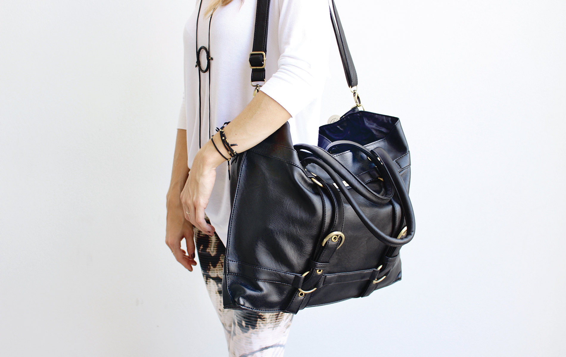 The Be Great shoulder bag by Maha Loka model with shoulder bag on white background