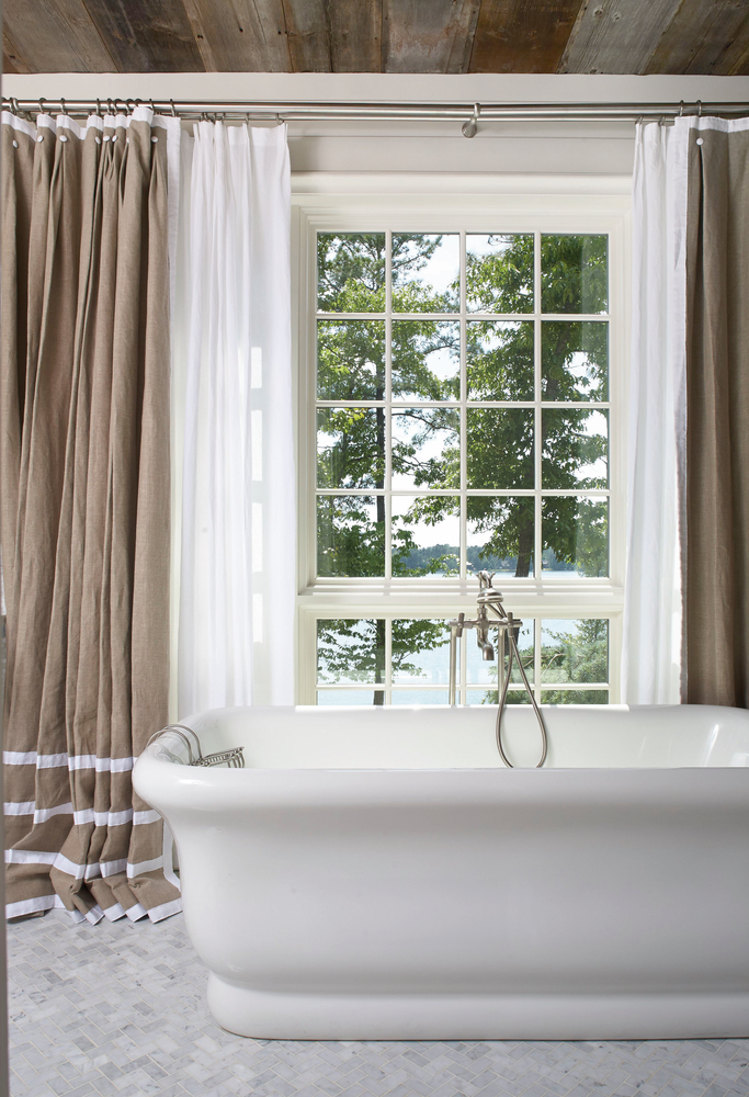 Gorgeous bathtub in front of large windows for natural lighting Lake Martin home
