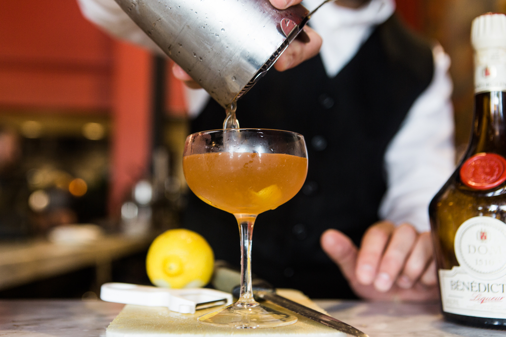 Bartender pouring a cocktail at Bottega restaurant Birmingham Alabama Frank Stitt
