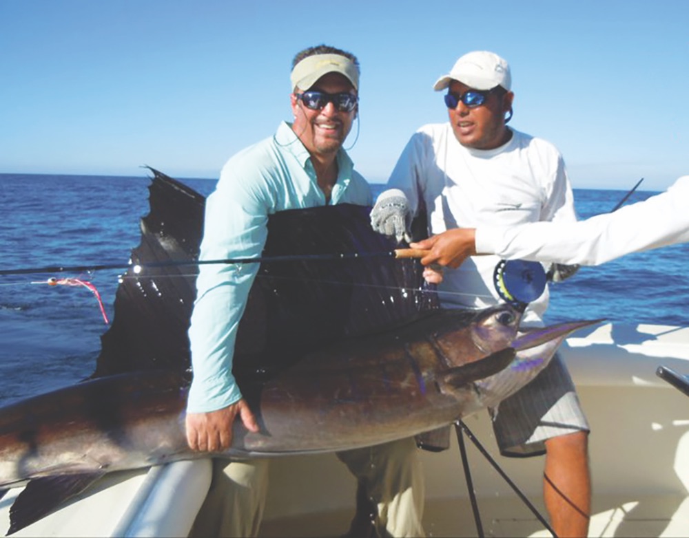 Author Darin Colucci (left) with his prized catch during a sailfish tournament in Guatemala
