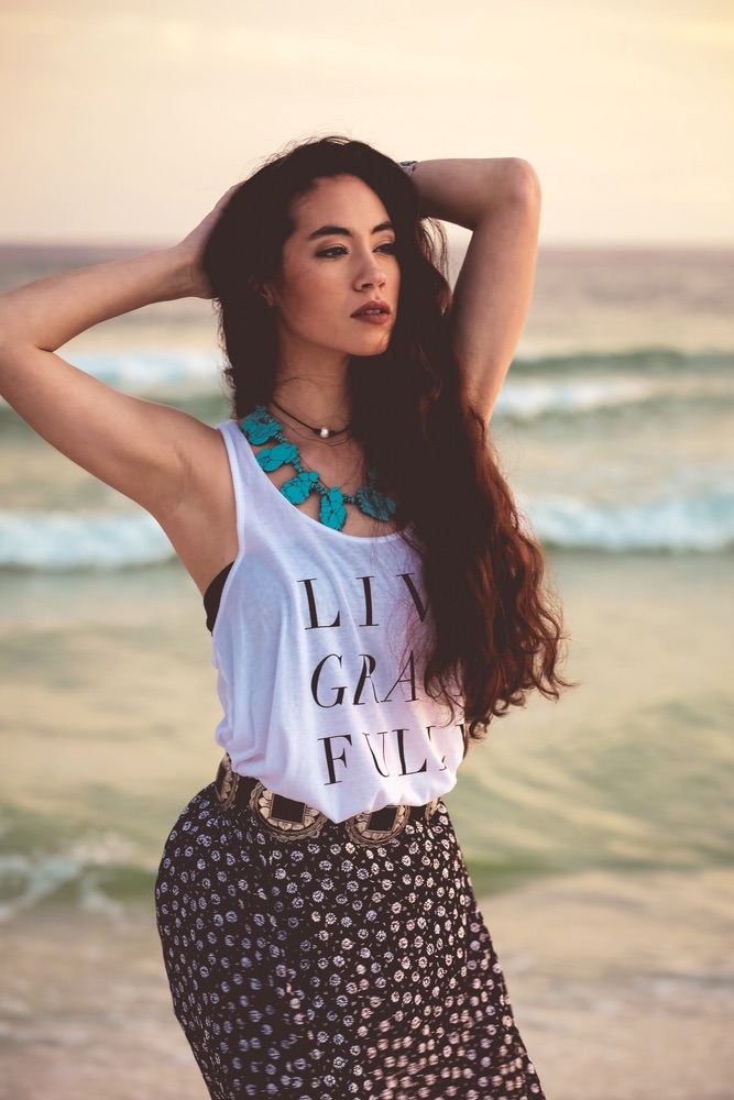 Beautiful model at the beach in a Graceful Rebel tank top Live Grace Fully