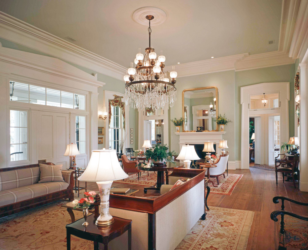 Tapered architraves in the classical Greek Revival style frame the windows and doors of the receiving room, which fills the depth of the home. Photo by Richard Leo Johnson