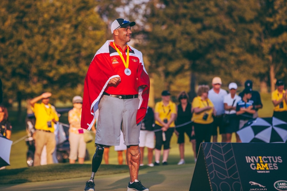 Golfer medalist standing on green after competing at the Invictus Games 2017 Toronto