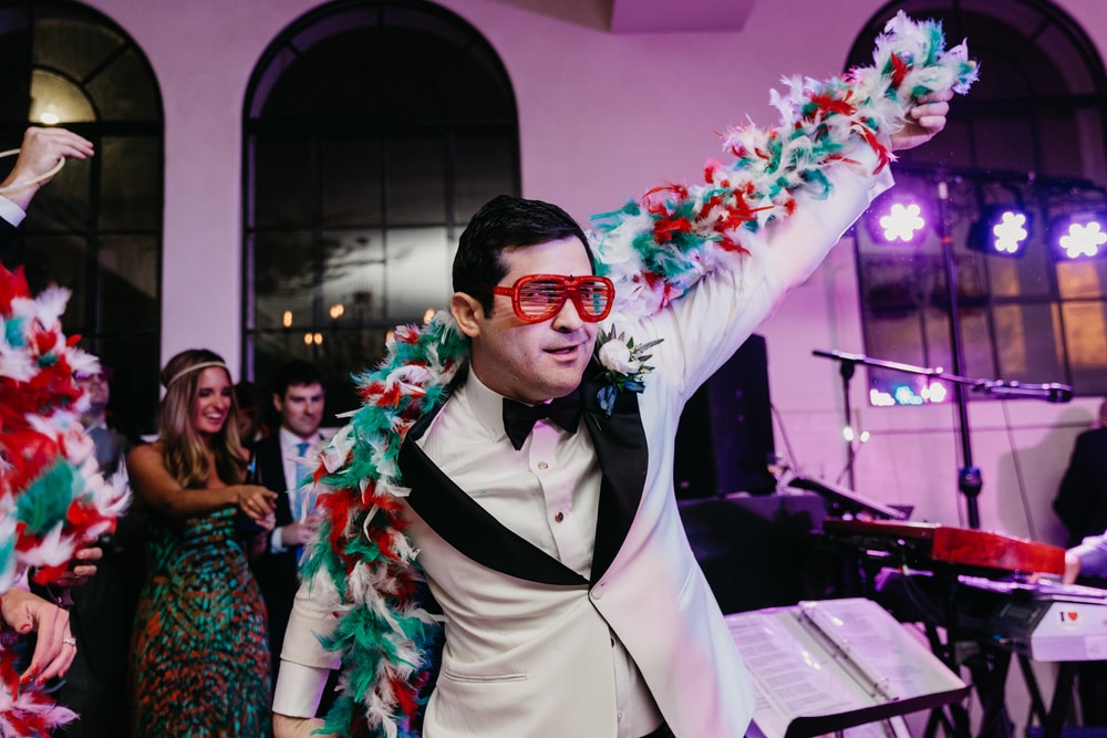 The groom Phillip Petitto dancing at his wedding reception adorned in Italian colors