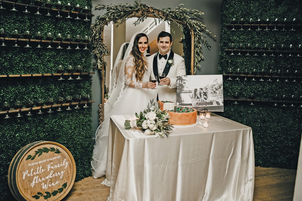 Sarah Elizabeth and Phillip Petitto cutting the grooms pizza cake at their big New Orleans Wedding