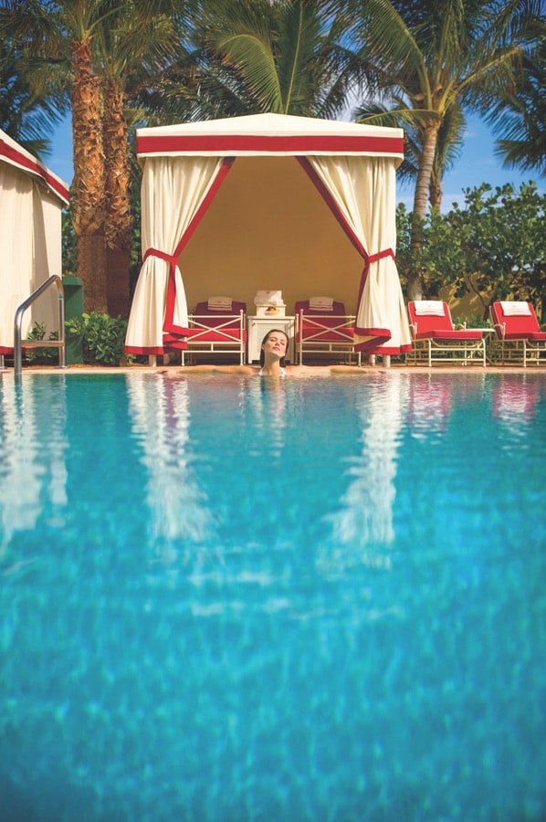 A woman relaxing poolside at Acqualine Resort & Spa.