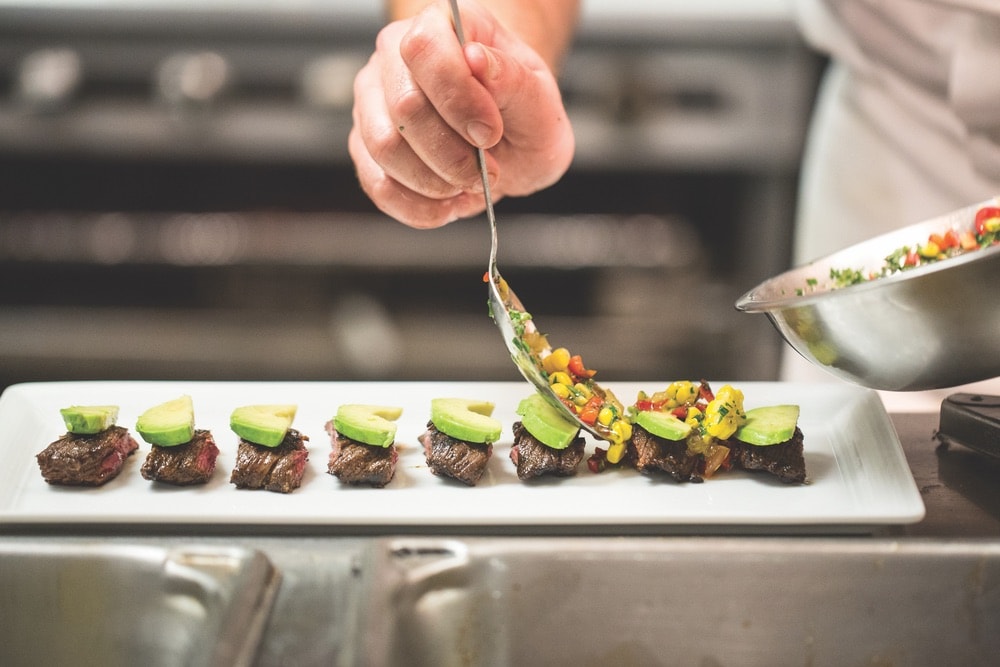 Chef Aaron Brooks plating a succulent steak dish at EDGE, Steak and Bar. Photo courtesy of EDGE, Steak and Bar