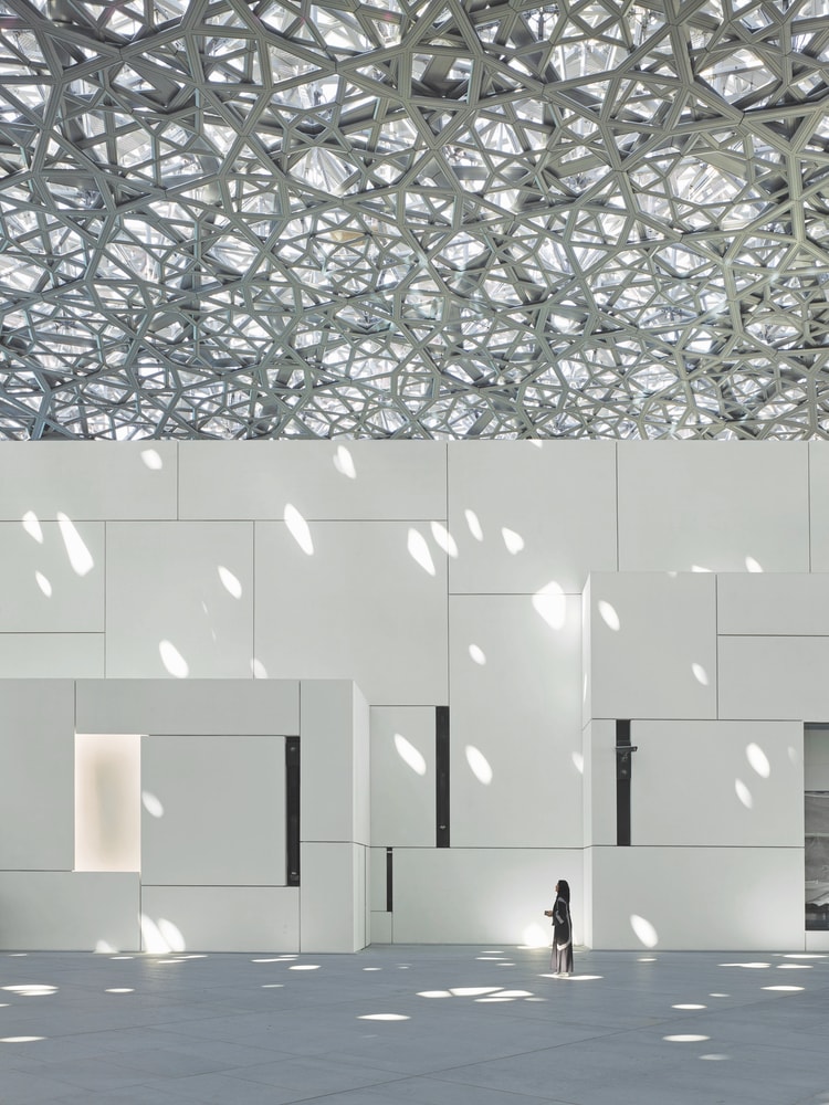 A breathtaking interior view of Louvre Abu Dhabi, featuring the masterfully designed dome VIE Magazine Destination Travel 2018
