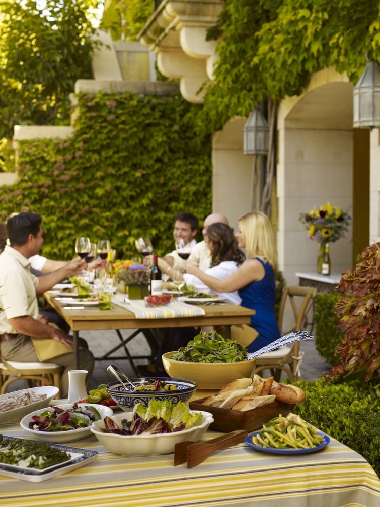 Jordan Vineyard and Winery; Group of people enjoying a dining experience and wine pairing on the vineyard grounds in Sonoma County, California.