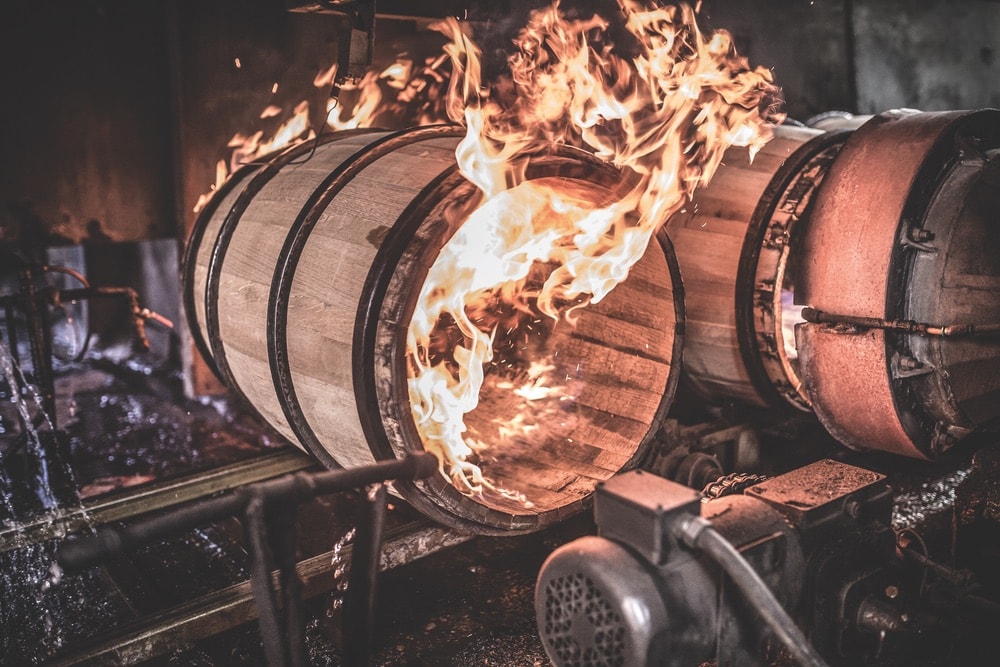 Barrels being fired to create a smoky-flavored bourbon
