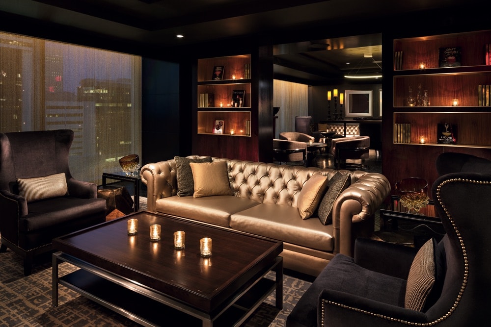 The Punch Room bar sitting area with a gold couch at the Ritz Carlton in Charlotte, North Carolina