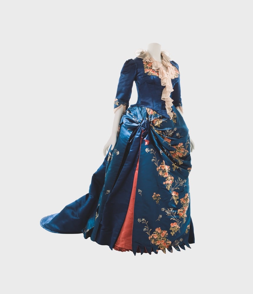 House of Worth blue, afternoon dress in satin brocaded with rose motifs, open skirt front over a panel of coral-colored satin.