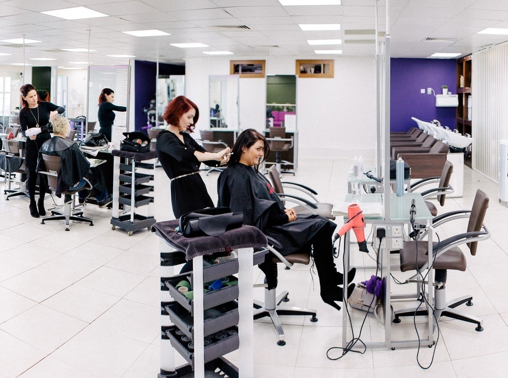 Bellissimo tribe members work with clients at their chic two-story salon and spa location in Galway, Ireland.