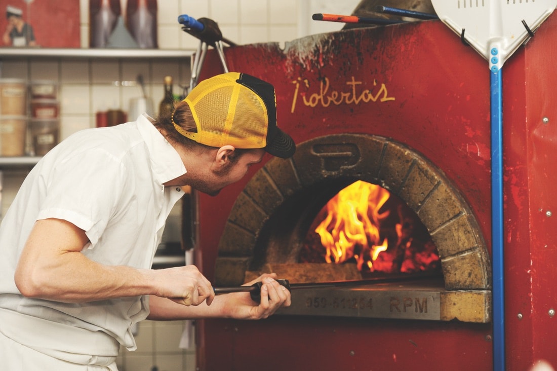 A chef preparing pizza