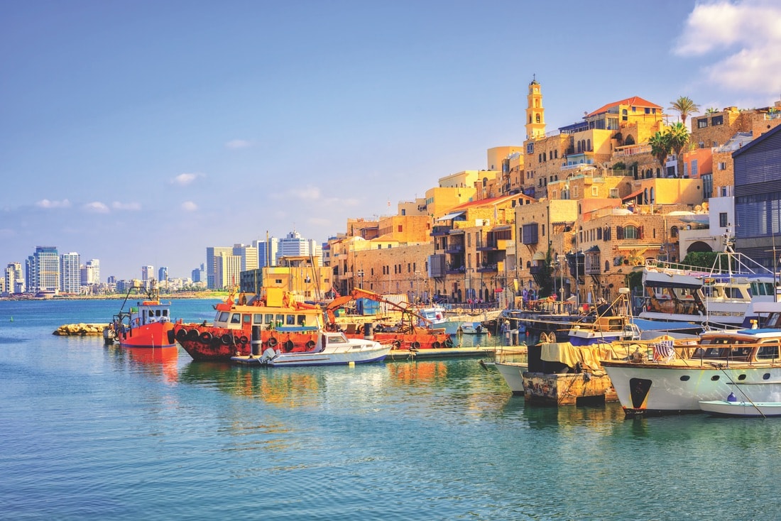 Tel Aviv’s colorful old town and port of Jaffa with the modern skyline in the distance