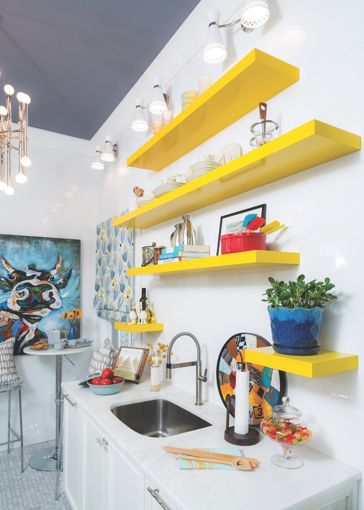 Pops of bright color and whimsical art liven up this kitchen design at the 1514 Home shop in Pensacola, Florida.