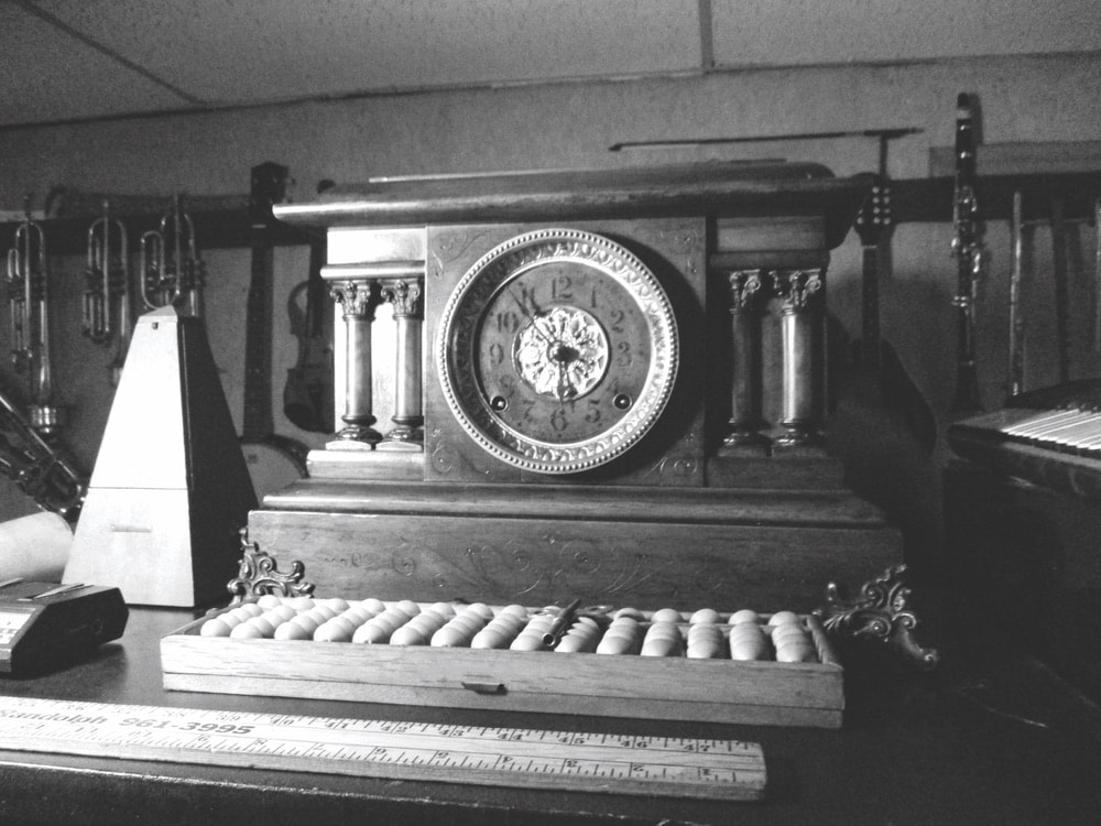 Seth Thomas Adamantine mantel clock sitting on a piano in black and white