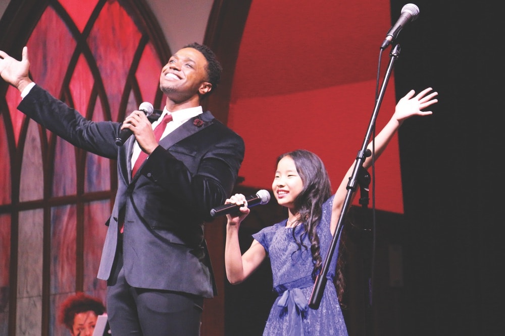 L. Steven Taylor of Broadway’s The Lion King on stage with a student during a performance of Break a Leg’s Rise Up! A Cabaret this past February.