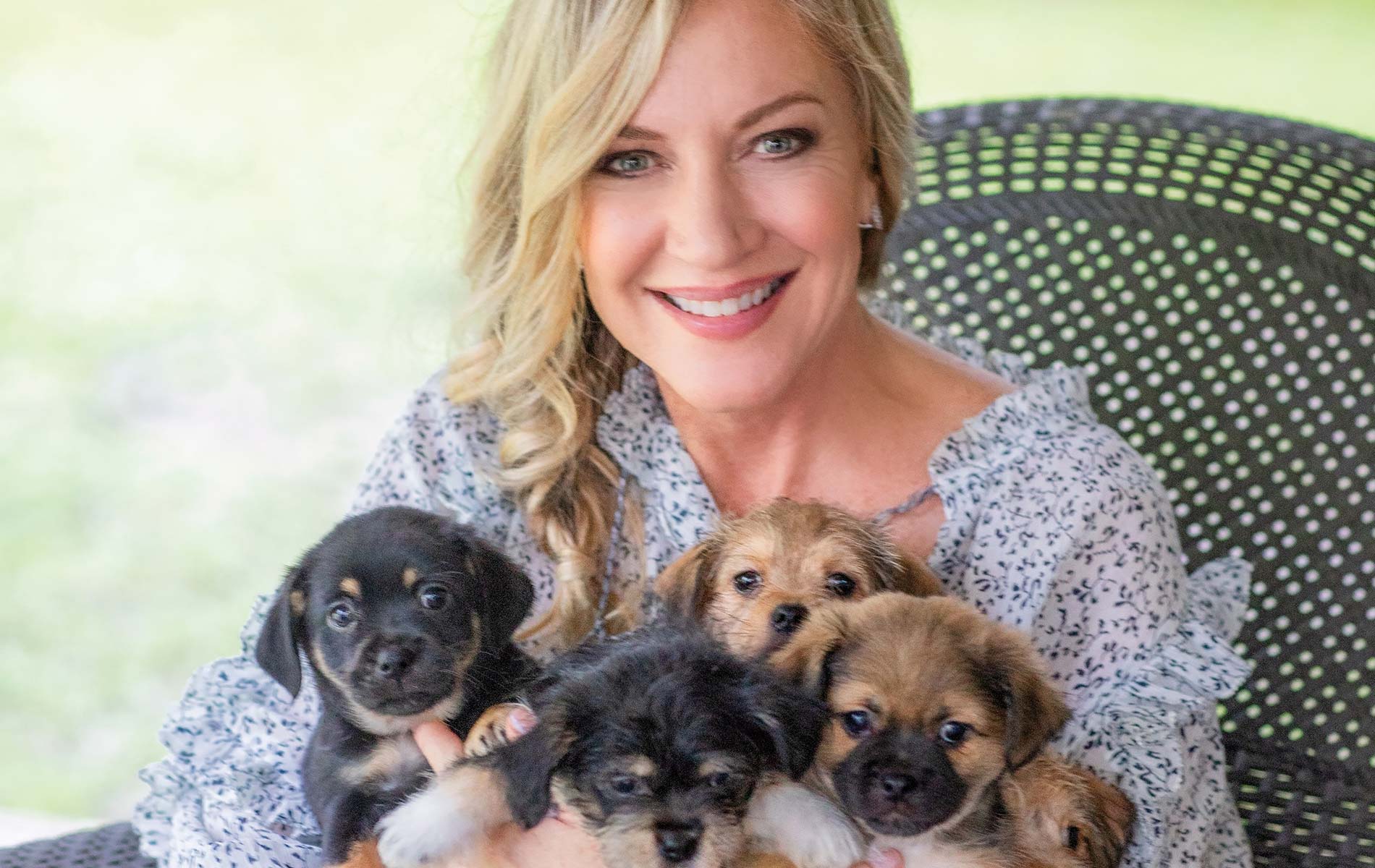 Laurie Hood with a recent rescue of adorable six-week-old puppies at the Alaqua Animal Refuge