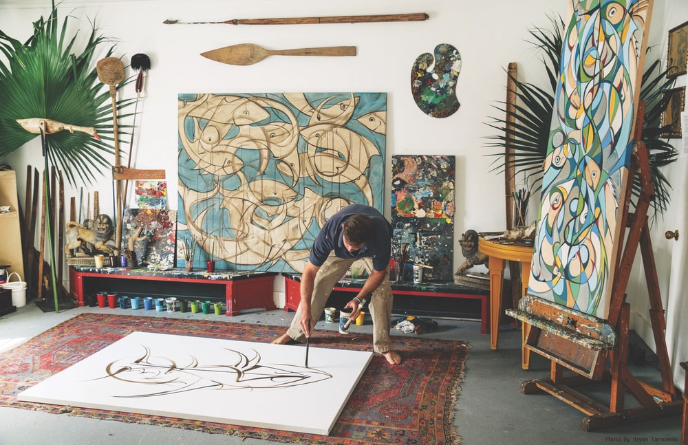 Beard in his studio working on a large canvas