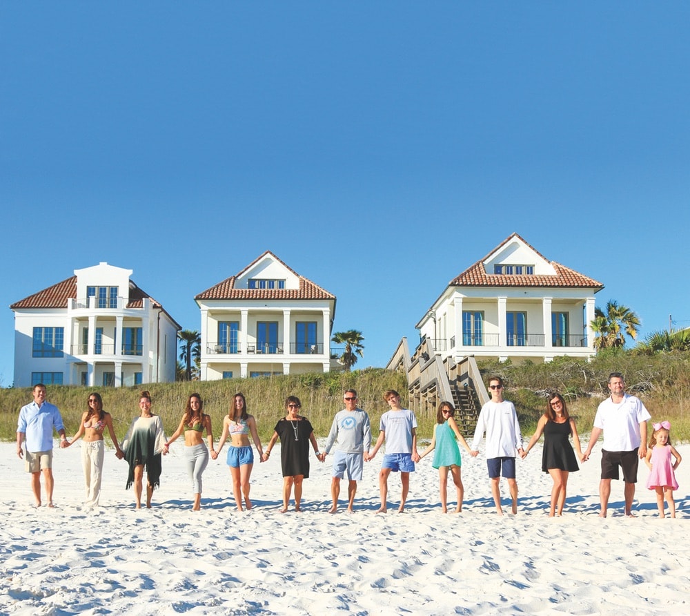 Broker of Rosemary Beach Realty and “The Smile of 30-A” Linda Miller with her family at the Escape compound’s 173 feet of white-sand beach