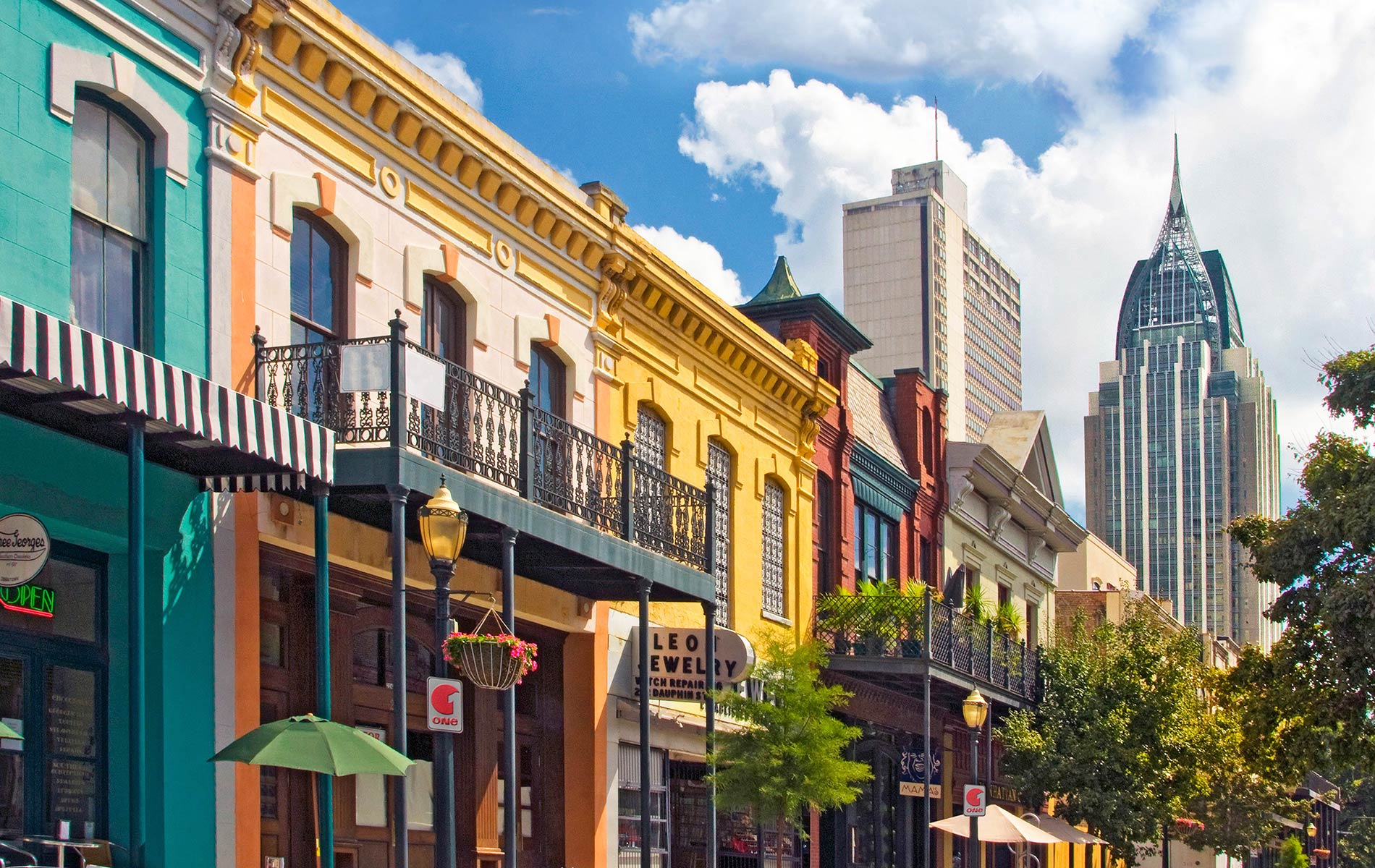Charming and colorful historic facades of old downtown are juxtaposed against the striking modern Mobile, Alabama skyline. 