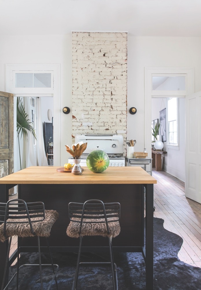 Dupré was sure to make use of space wisely throughout the small shotgun house; for example, the movable kitchen island doubles as a dining space.