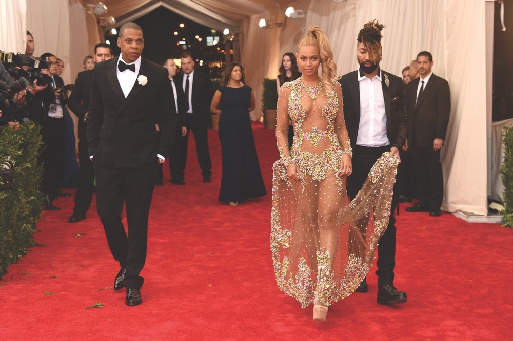 Ty Hunter assists Beyoncé as she walks the red carpet with husband Jay-Z at the 2015 Met Gala.