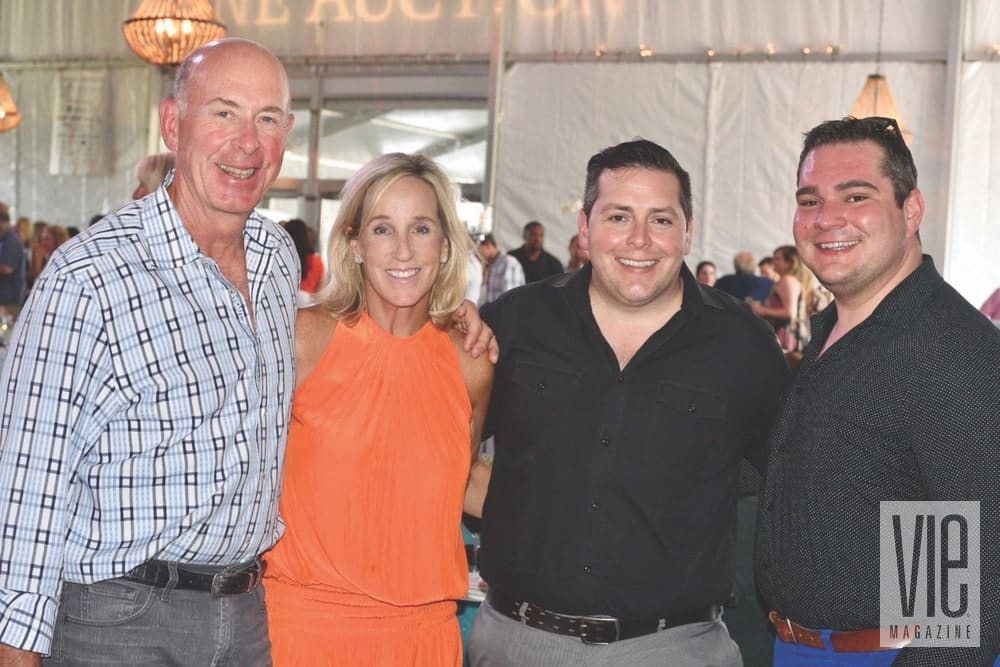 Steve and Mary Ellen Buffington, Demetrius Fuller, and Jimmy Chambers at the Destin Charity Wine Auction Foundation (DCWAF) event