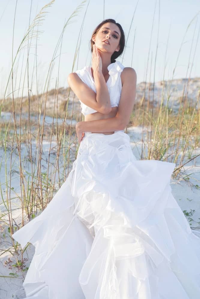 Nicole Paloma Bridal, one model in a wedding gown on the beach