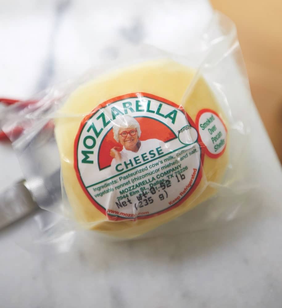 A ball of Paula Lambert's Mozzarella cheese with her face on the label wrapped in plastic