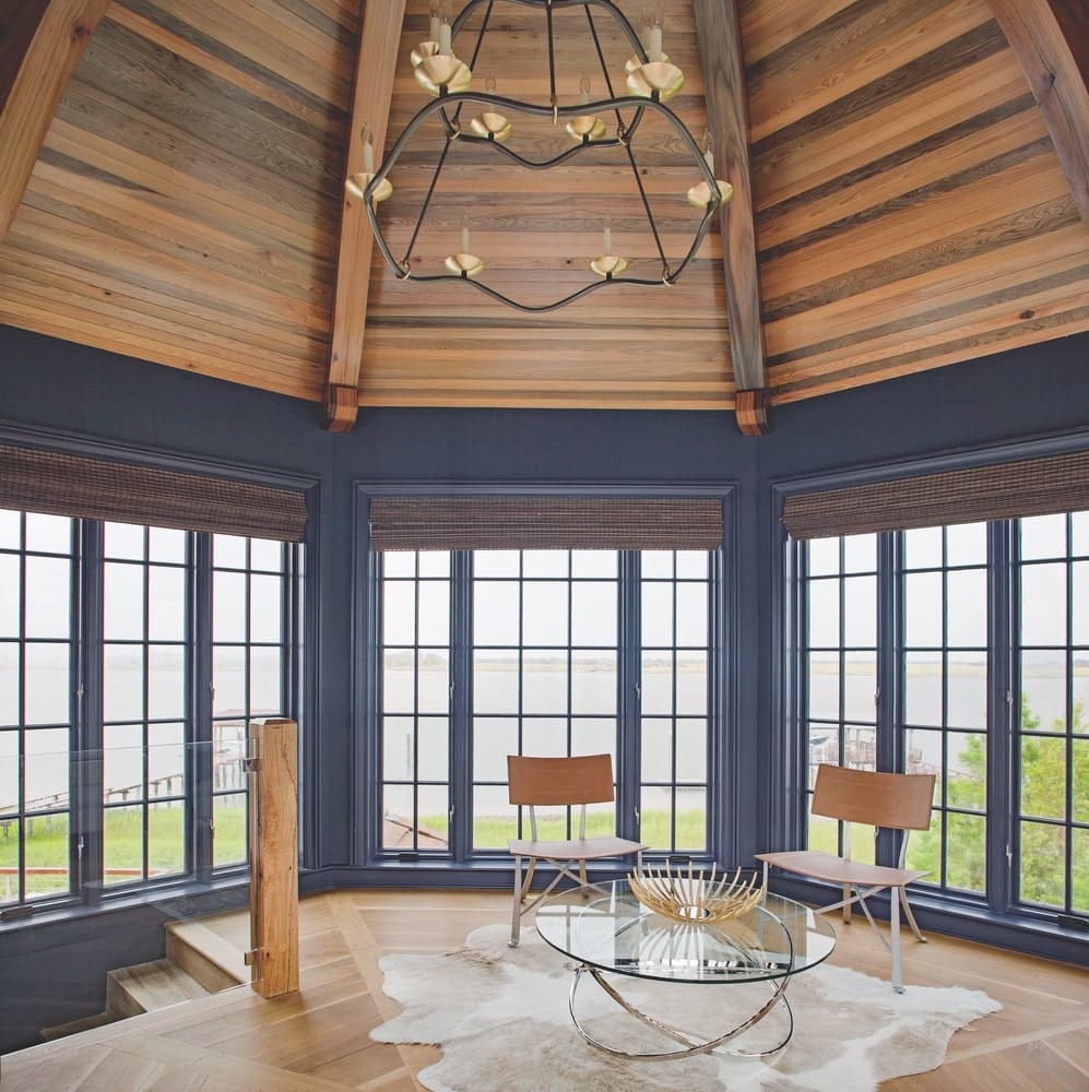 View of a room with 360 views of windows looking at the home's property shot by Richard Leo Johnson