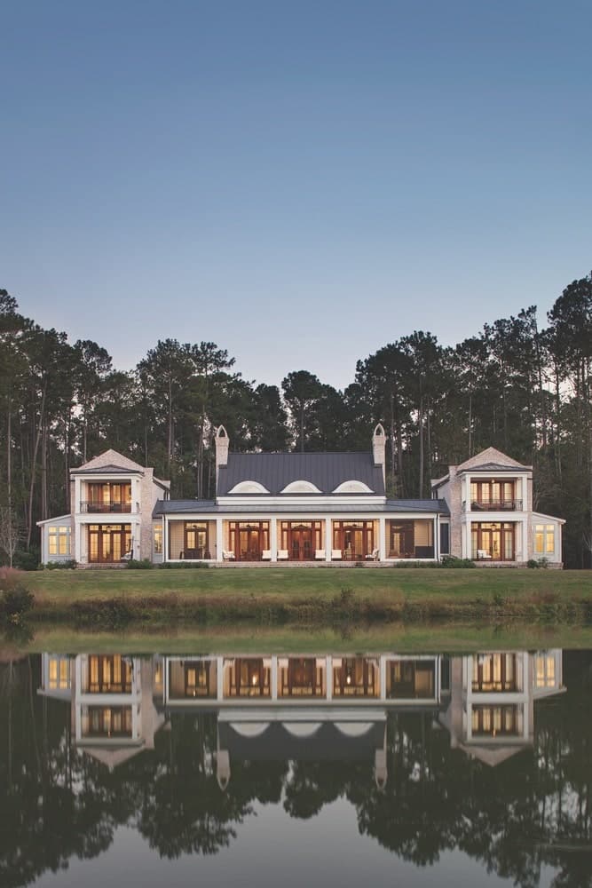 Exterior of a symmetrical, Southern red bricked home sitting on the waters edge shot by Richard Leo Johnson
