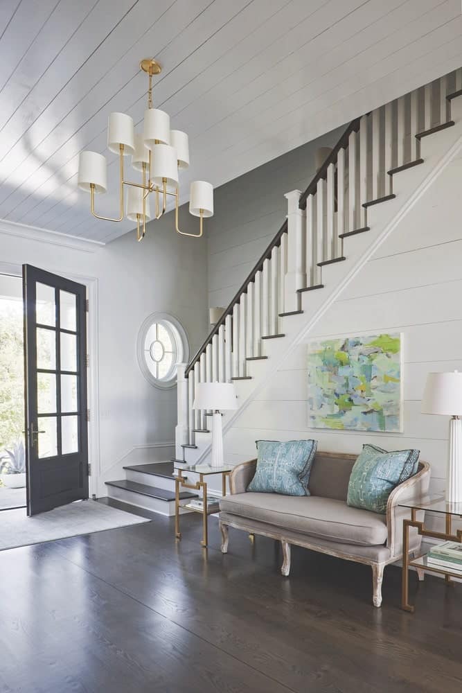 Front door and stairwell showing off white wood walls and dark wood floors shot by Richard Leo Johnson