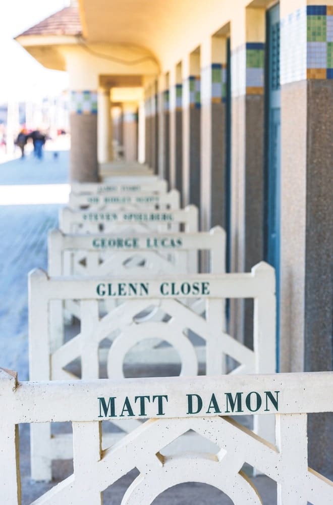 In Deauville, barriers outside the beach huts on Les Planches bear the names of famous filmmakers and actors.