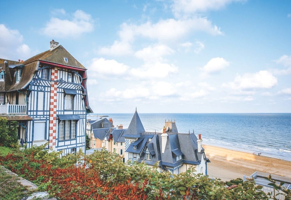 The morning light on the beach and homes of Trouville makes it obvious why the town is a perfect vacation destination.
