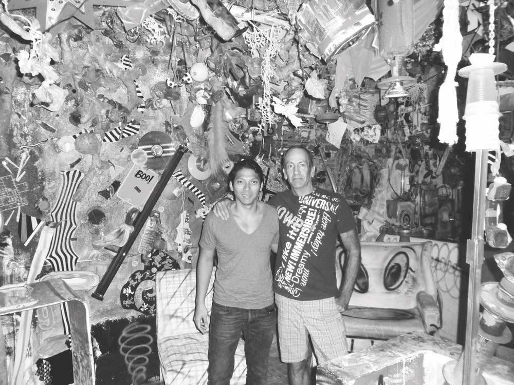 Black and white image of Robbie Antonio with L.A.–based artist Kenny Scharf standing in front of Kenny's artwork
