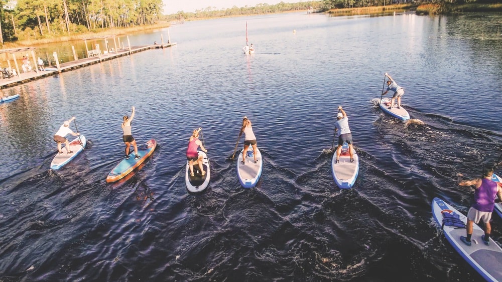 Local athletes paddle across Western Lake for a run through Grayton Beach State Park at Fit For Hope’s pop-up event with RUN/SUP. | Photo courtesy of Fit For Hope