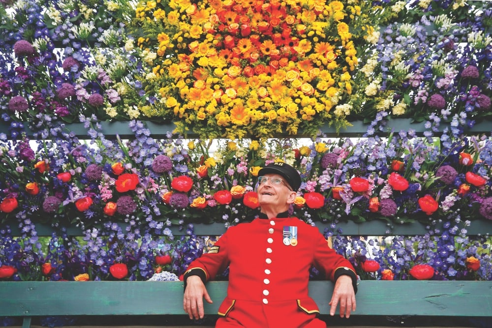 Chelsea Pensioner Paul Whittick enjoys the display at the Marks & Spencer Floral Market exhibition during press day at the RHS Chelsea Flower Show 2018.