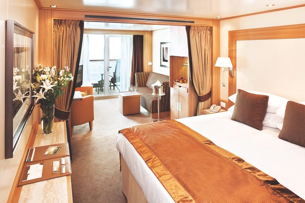 Seabourn’s Veranda suites feature a living area, a queen-size bed or two twin beds, full-length windows and a glass door to a private veranda, and more. | Photo courtesy of Seabourn