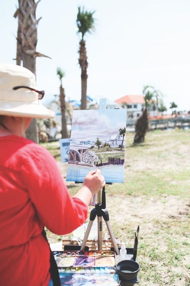 Artist Brienne M. Brown of Julian, Pennsylvania, paints near the welcome center in Mexico Beach, Florida, during the 2019 Forgotten Coast en Plein Air event.