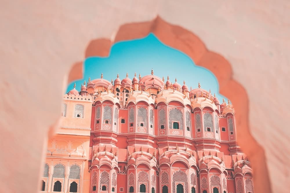 Hawa Mahal—the Palace of Winds—lies on the edge of Jaipur’s City Palace. Its many-windowed facade was originally designed not only to allow air to flow more freely into the rooms, but also to enable the ladies of the palace to look out upon the streets and activities below without being seen. Red and pink sandstone give the rosy hue to the area’s buildings, earning Jaipur its modern nickname, the Pink City.